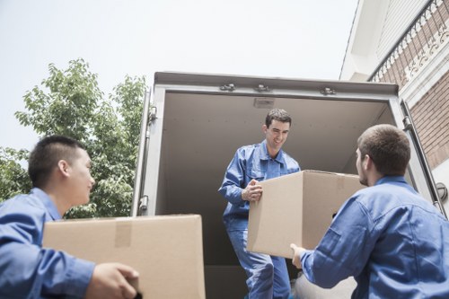 Careful unloading of household items at a new Enfield property