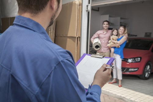 Removal team loading household items for transport in Enfield