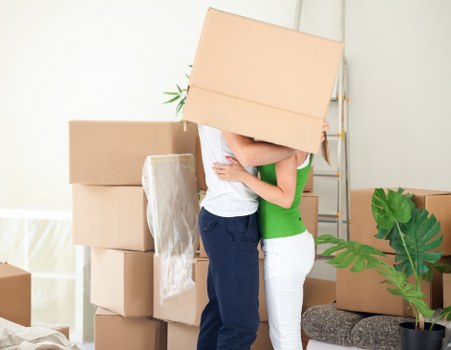 Packed moving boxes and furniture organized for Enfield removals