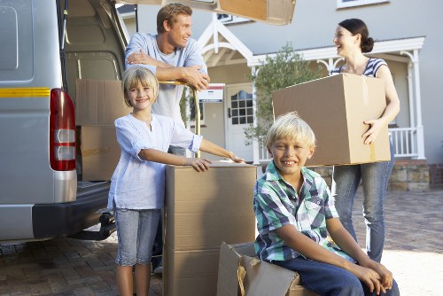 Local movers loading furniture in a residential Enfield street
